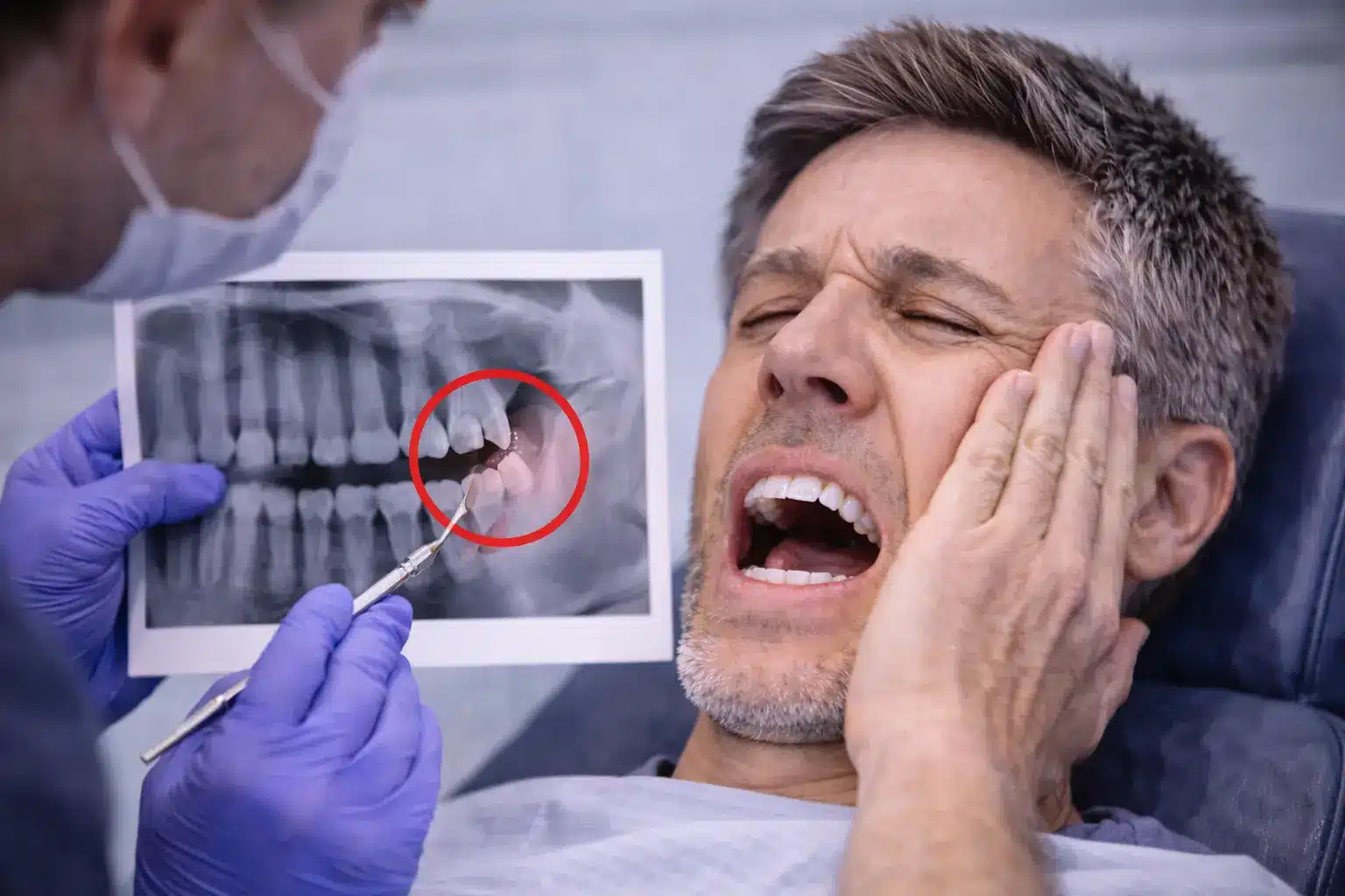Dentist showing an X-ray to a patient with toothache