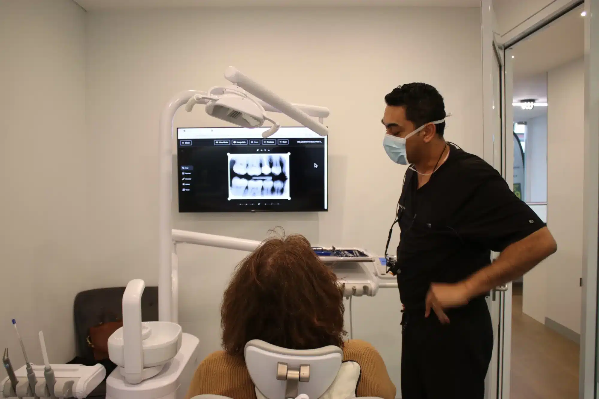 Dentist reviewing a patient’s dental X-rays at Hayat Dental